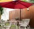 Wooden deck with stone floor in the backyard. Patio with chairs and umbrella for outdoor seating and dining with